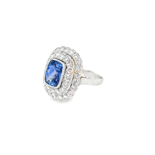 Side view of the platinum cushion sapphire ring, showing the double diamond halo and the tapered band