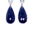 Pear sapphire earrings detail: faceted pear-shaped blue sapphire drops in claw settings, 18kt white gold