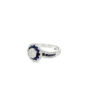 Side view of the royal blue sapphire ring showing the raised flower head and channel-set sapphires along the shoulder