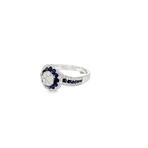 Side view of the royal blue sapphire ring showing the raised flower head and the channel of sapphires with pave diamond edges along the shoulder