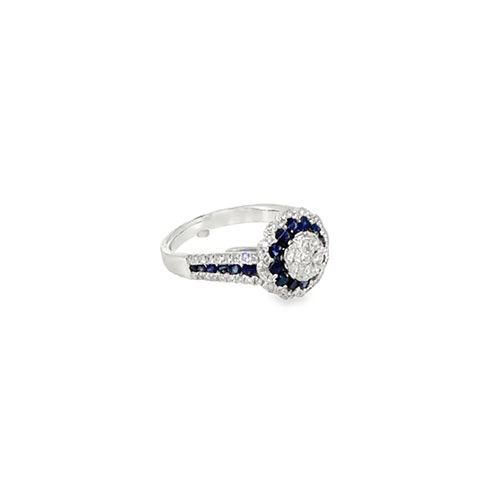The royal blue sapphire ring from the other side, showing the scalloped diamond outline and the tapering white gold band