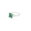 Side view of the emerald cut emerald ring showing the four corner prongs, the tapered baguettes and the slim platinum band