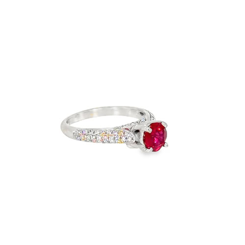 Angled view of the lab grown ruby ring, showing the diamond shoulders tapering toward the plain lower band